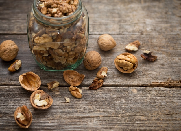 Walnuts on rustic old wooden table