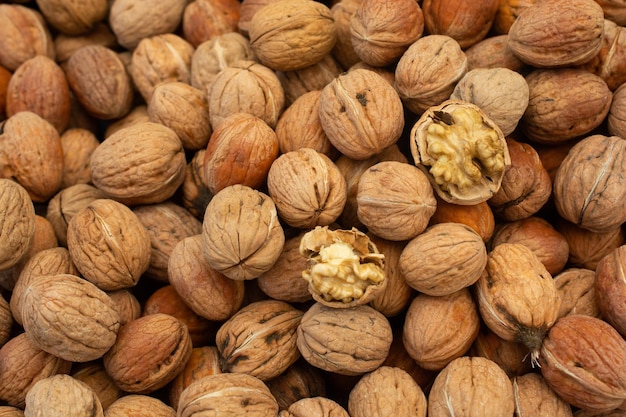 Walnuts in shell heap pattern as organic food background