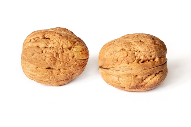 Walnuts in shell on white isolated background with shadow Full depth of field