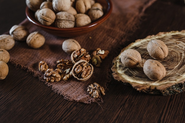 Walnuts. Walnut kernels and whole walnuts on black table