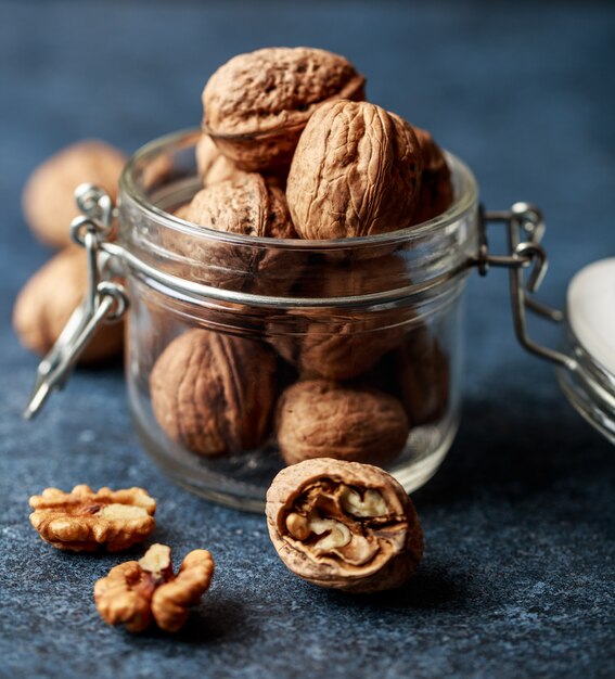 Walnuts. Walnut kernels and whole walnuts on rustic table.