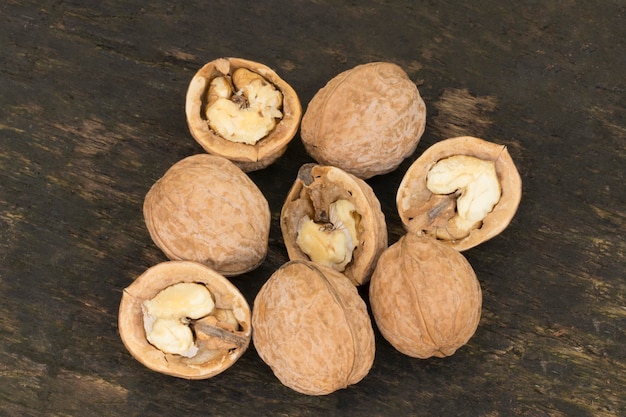 Walnuts, walnuts close-up, walnuts on a dark background, walnuts on a wooden table, walnuts on a dark wooden background