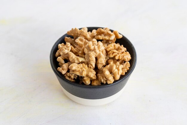 Walnuts on a white wooden background