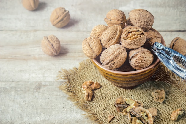 Walnuts on wooden background. Selective focus.