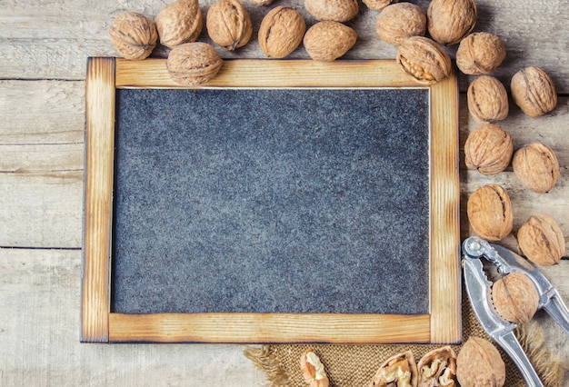 Walnuts on wooden background. Selective focus.