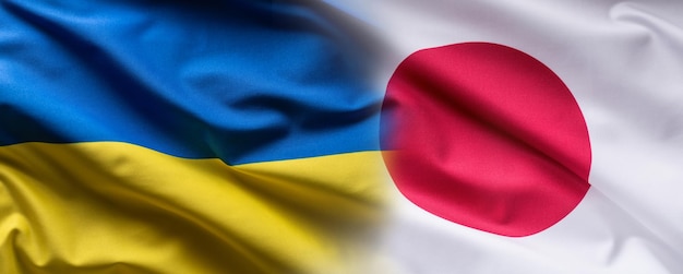 Wapperende vlag concept van Oekraïne en Japan symboliseren politieke verbinding