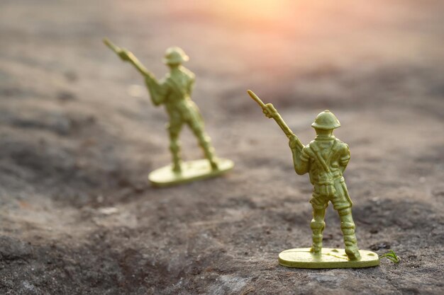 War concept Toy soldiers outdoors at sunset