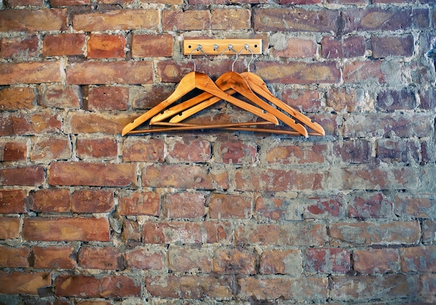 Wardrobe hangers at bricks wall