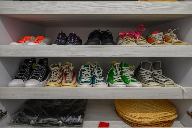 Wardrobe with different shoes at shelves