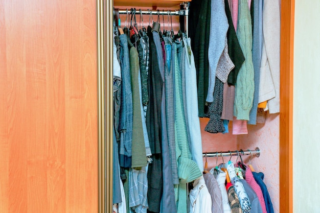 Photo wardrobe with open door filled with clothes