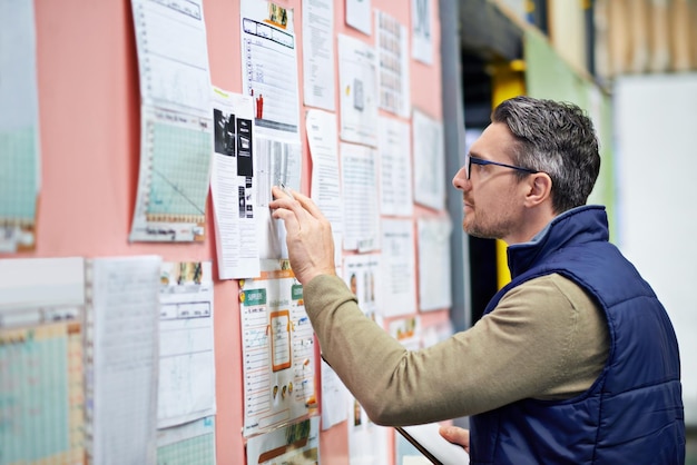 warehouse man and board in business for planning or operations shipping or logistics or management male person clipboard and schedule in workplace for review or job inventory or supply and check
