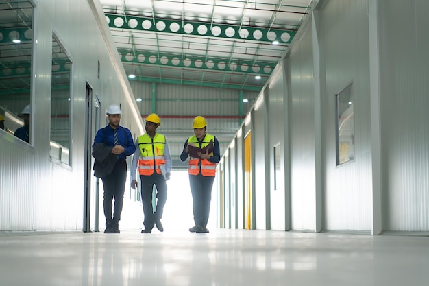The warehouse manager advises the two employees on how to organize the shelves in a vast warehouse