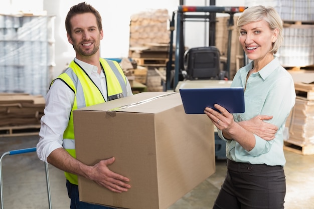 Warehouse manager and foreman working together