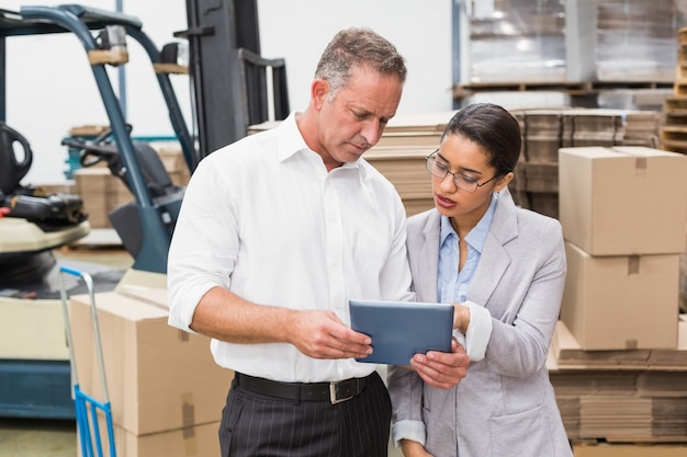 Warehouse manager and her boss working together