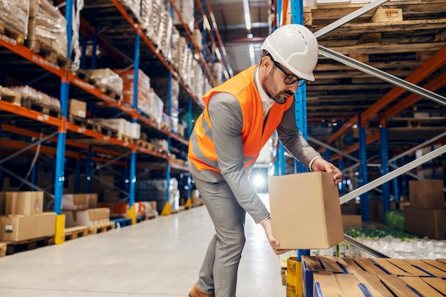 A warehouse manager is organizing boxes with goods in storage