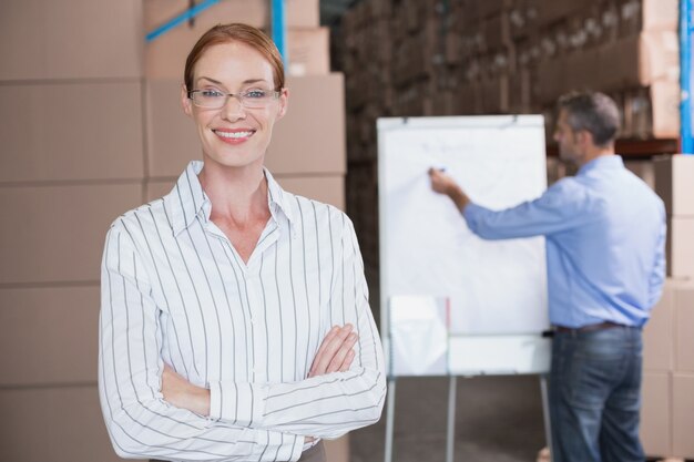 Warehouse manager smiling at camera