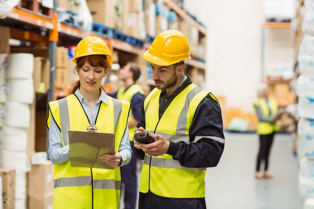 Warehouse manager talking with worker