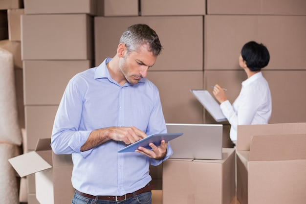 Warehouse manager using his tablet pc