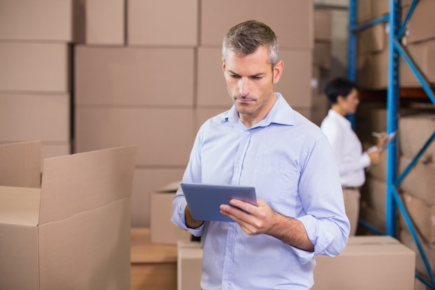 Warehouse manager using his tablet pc