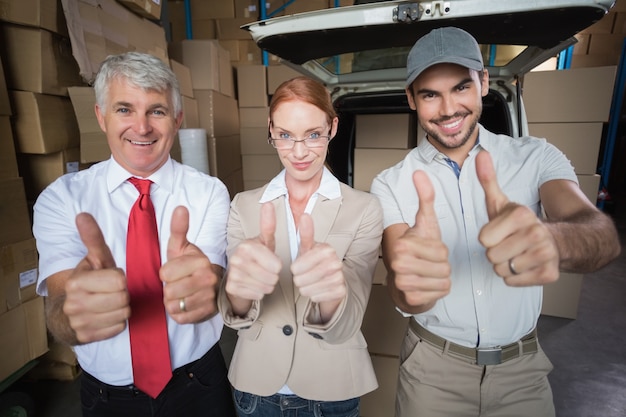 Photo warehouse managers and delivery driver smiling at camera