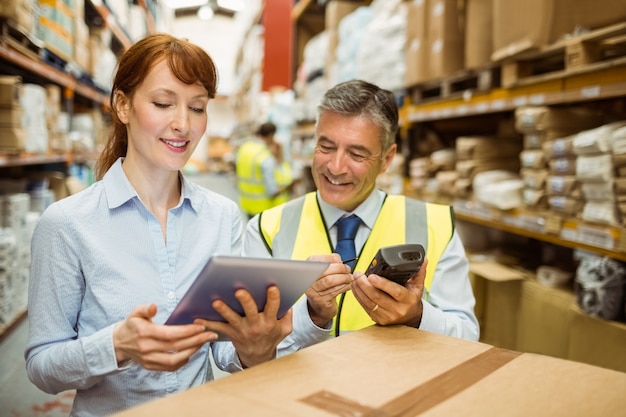 Warehouse managers looking at tablet pc