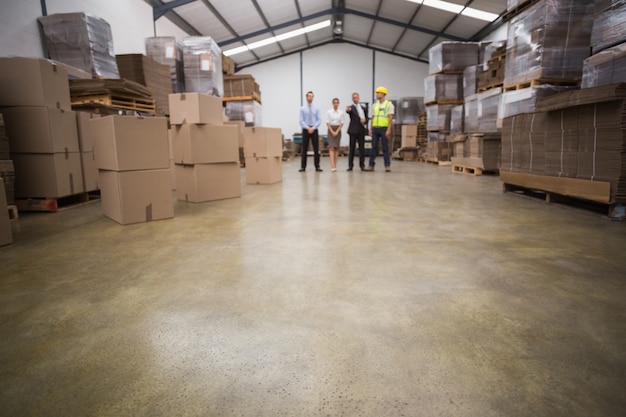 Warehouse managers and worker talking together