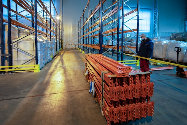 Warehouse premises of a factory or workshop with metal shelves.