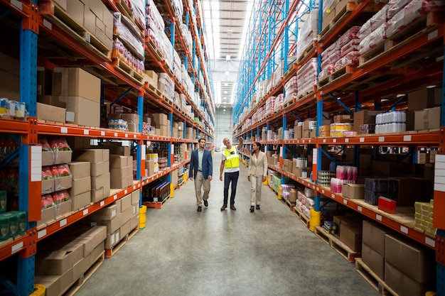 Warehouse team discussing while walking