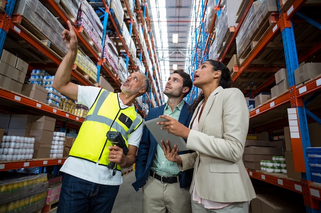 Warehouse team discussing with digital tablet