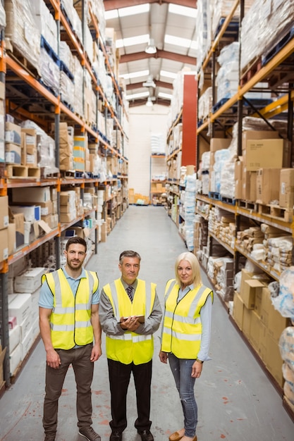 Warehouse team smiling at camera