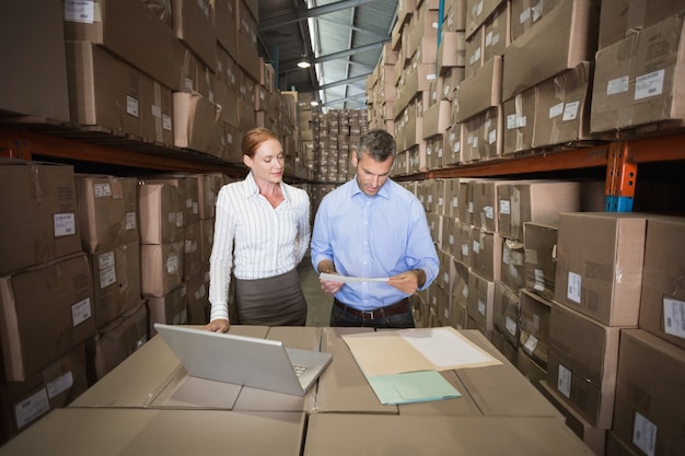 Warehouse team working together on laptop