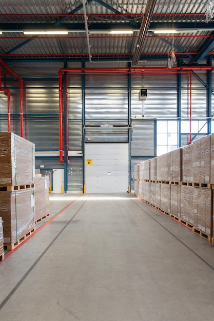 Warehouse with a loading door and pallets with boxes