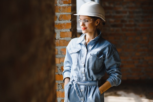 Warehouse woman worker. Woman builder in hardhat.