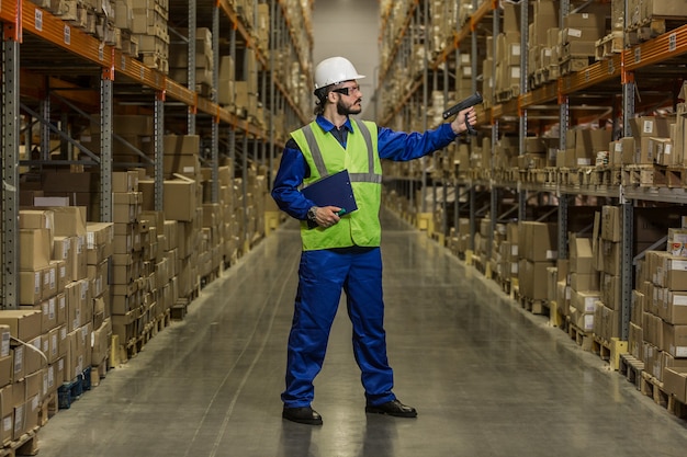 Warehouse worker checking cargo on shelves with scanner