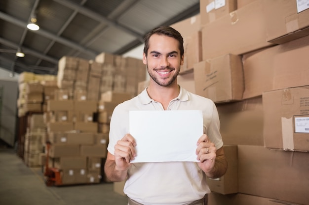 Warehouse worker holding blank board