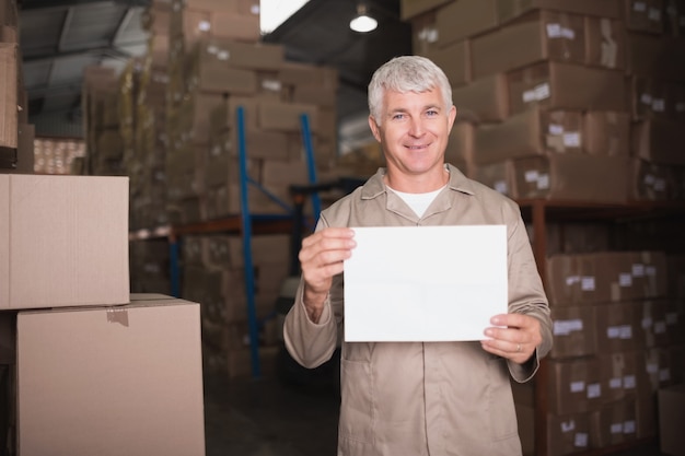 Warehouse worker holding blank board