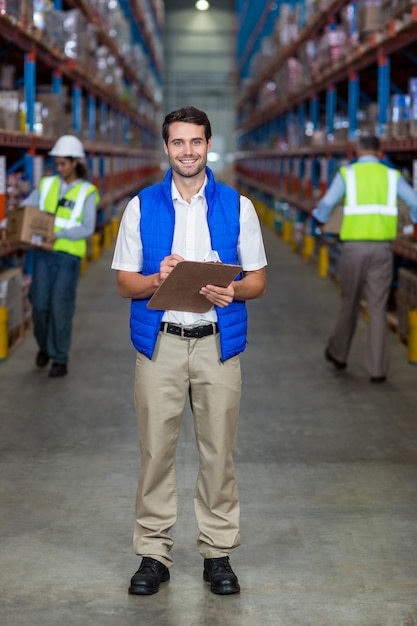 Warehouse worker holding clipboard