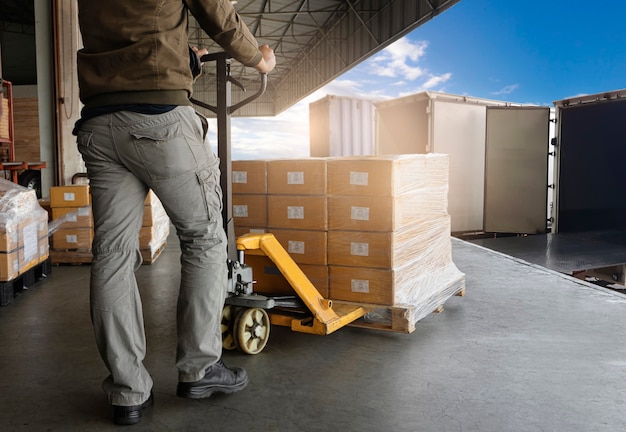 warehouse worker loading package boxes into shipping container truck