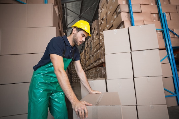 Warehouse worker loading up a pallet 