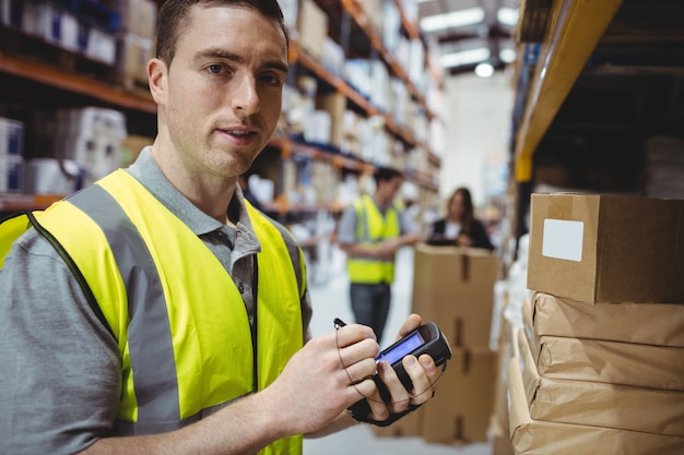 Photo warehouse worker scanning box in warehouse