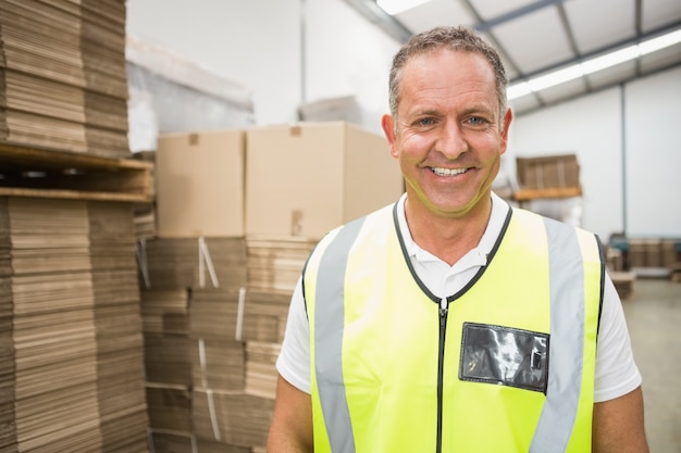 Warehouse worker smiling at camera