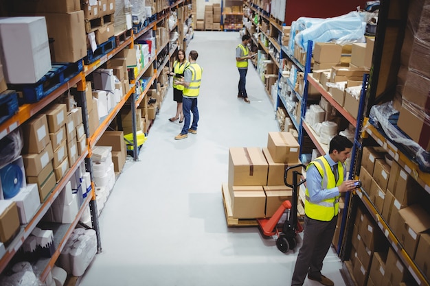 Warehouse worker using hand scanner in warehouse