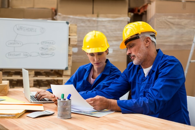 Warehouse workers discussing with each other