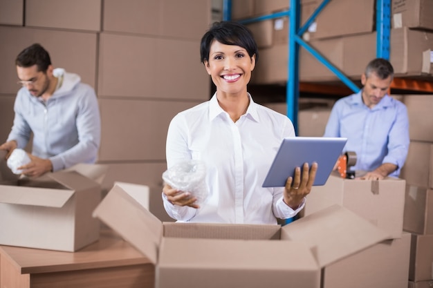 Warehouse workers packing up boxes