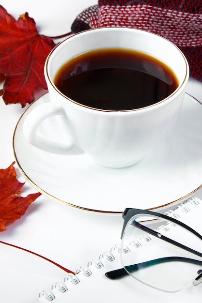 Warm checkered plaid and cup of hot espresso coffee on white background Hello autumn concept