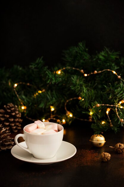 Warm cocoa drink with marshmallows. Christmas and New Year drink. Christmas Eve mood. Winter holidays concept. Dark background. Vertical. Copy space