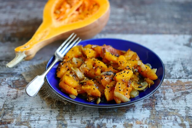 Warm dish with pumpkin Baked pumpkin with onions