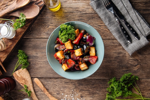 Warm eggplant salad with vegetables in a bowl