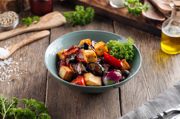 Warm eggplant salad with vegetables in a bowl