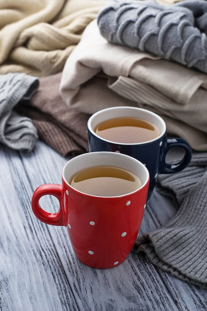 Warm knitted pastel clothes and cups